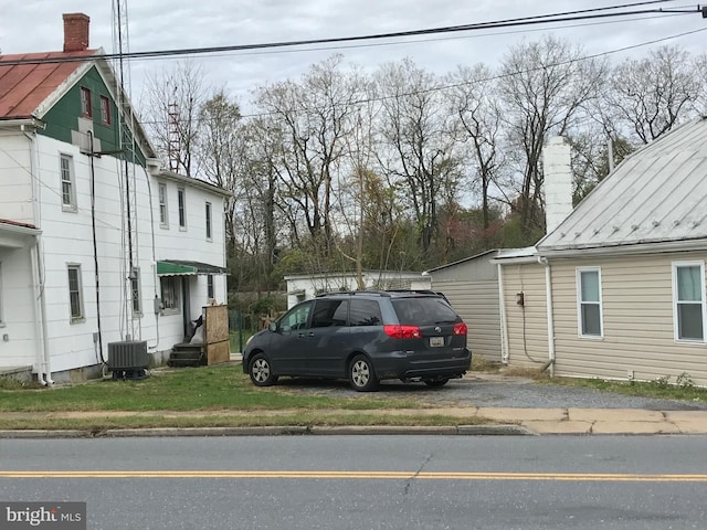 view of side of home with central air condition unit