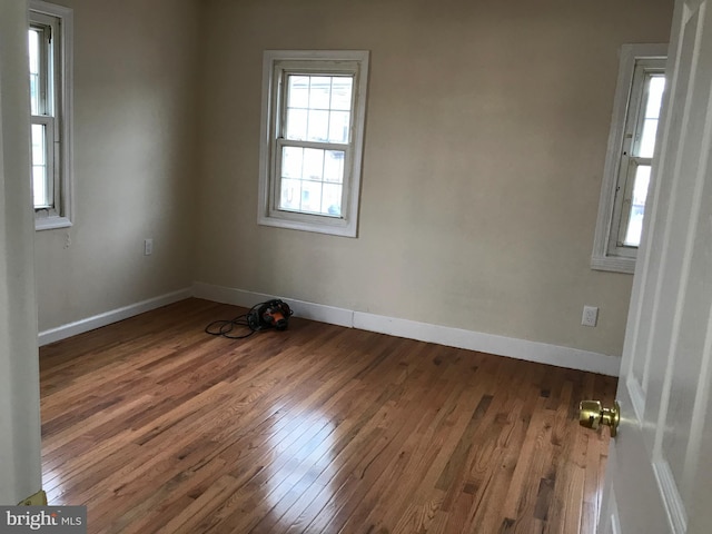 spare room with dark hardwood / wood-style floors