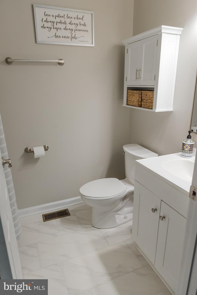 bathroom featuring vanity and toilet