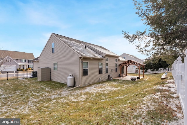 back of property featuring a gazebo, a yard, and a patio