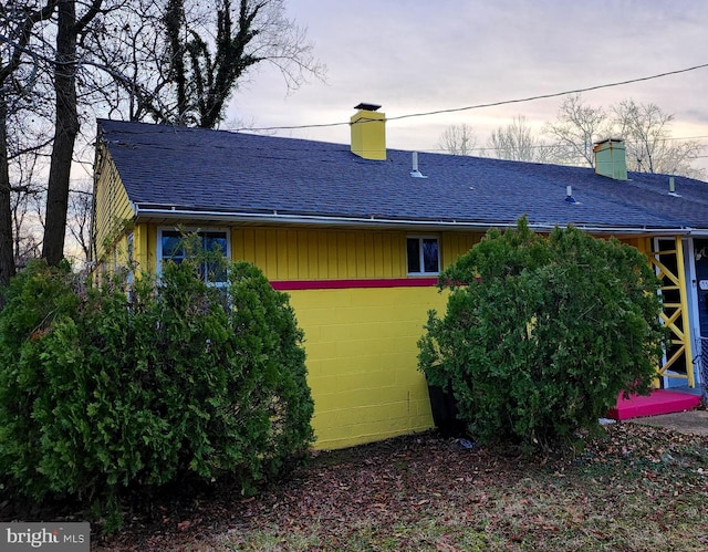 view of back house at dusk