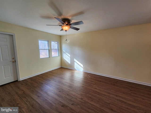 empty room with ceiling fan and dark hardwood / wood-style floors