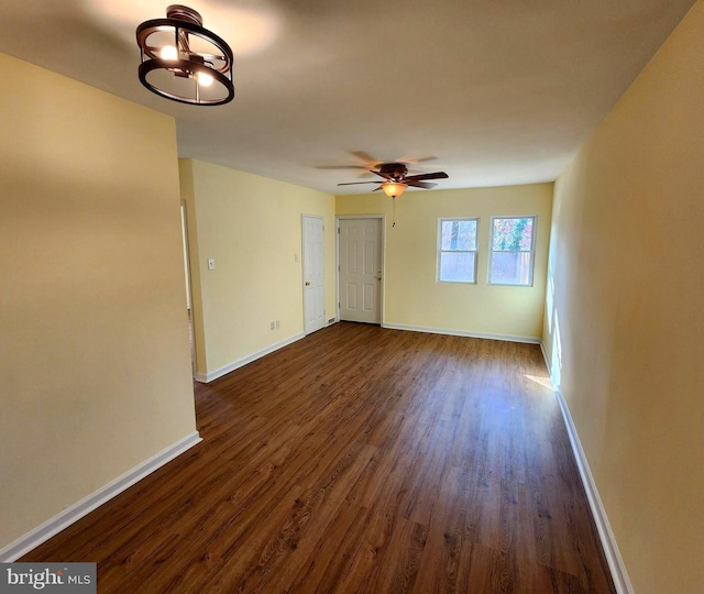 empty room with dark hardwood / wood-style flooring and ceiling fan