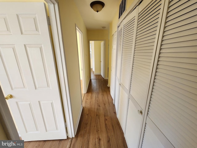 hall with hardwood / wood-style flooring