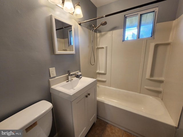 full bathroom with tile patterned flooring, vanity, washtub / shower combination, and toilet