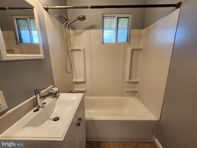 bathroom with vanity and washtub / shower combination