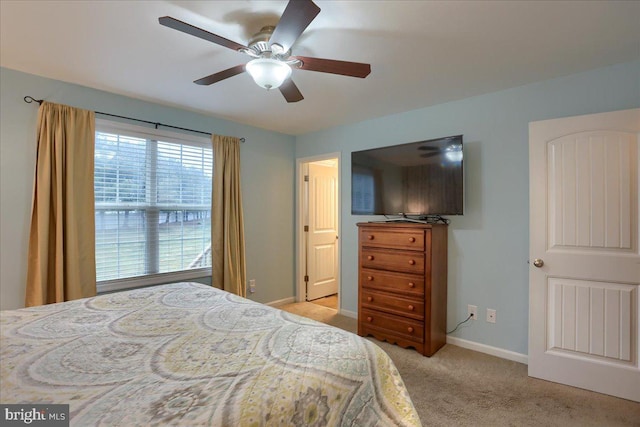 bedroom with ceiling fan and light colored carpet