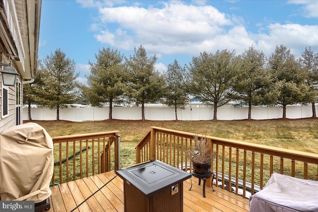 wooden terrace with area for grilling and a lawn