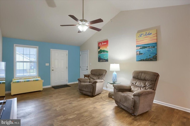 sitting room with hardwood / wood-style flooring, ceiling fan, and high vaulted ceiling