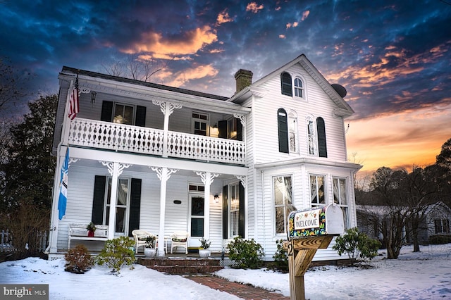 view of front of property with a balcony and covered porch