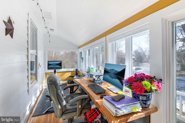 office area with hardwood / wood-style flooring and vaulted ceiling