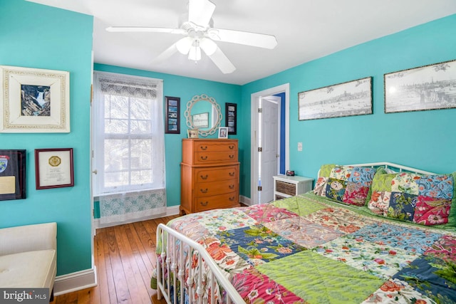 bedroom featuring hardwood / wood-style flooring and ceiling fan