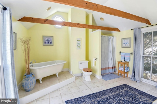 bathroom with tile patterned flooring, a tub to relax in, lofted ceiling with beams, and toilet