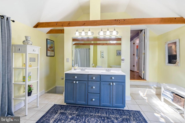 bathroom featuring vaulted ceiling, tile patterned floors, and vanity