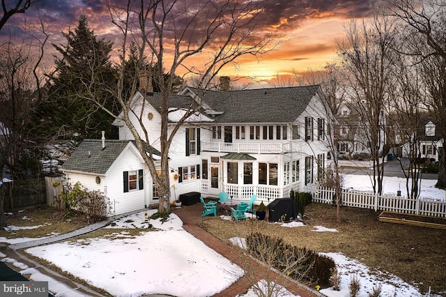 snow covered property with a balcony