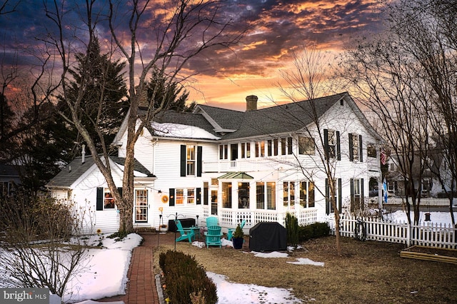 view of snow covered rear of property