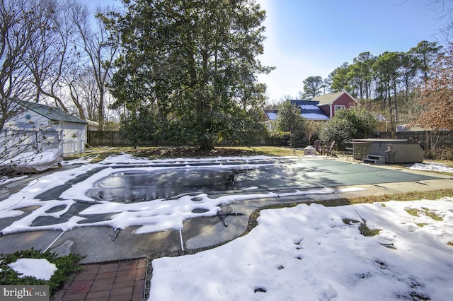 snow covered pool featuring a hot tub