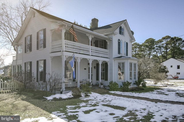 view of front of property featuring a balcony and covered porch