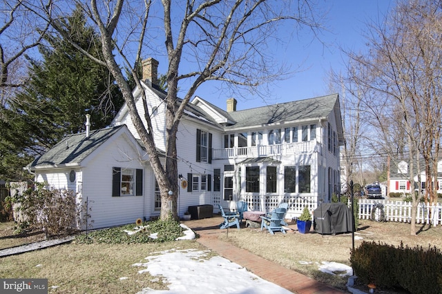 back of property with a balcony