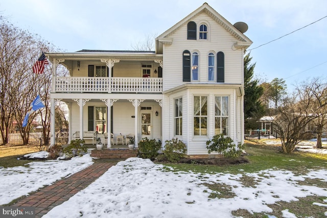 view of front facade with a balcony and a porch