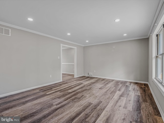 empty room with crown molding and hardwood / wood-style flooring