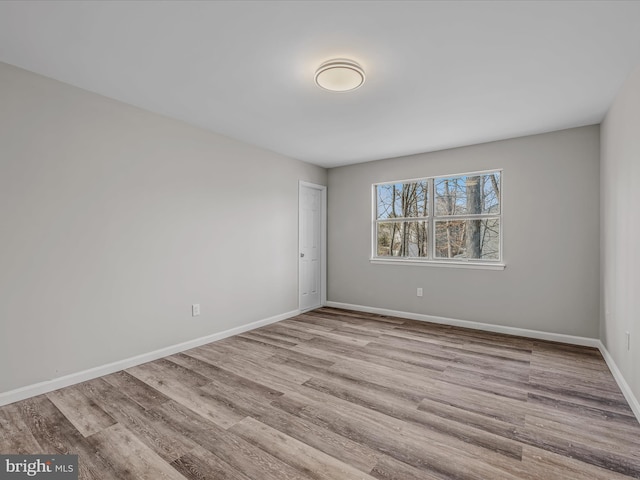 unfurnished room with light hardwood / wood-style floors