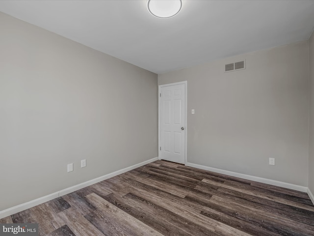 spare room with dark wood-type flooring