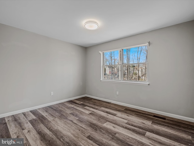 unfurnished room with hardwood / wood-style flooring