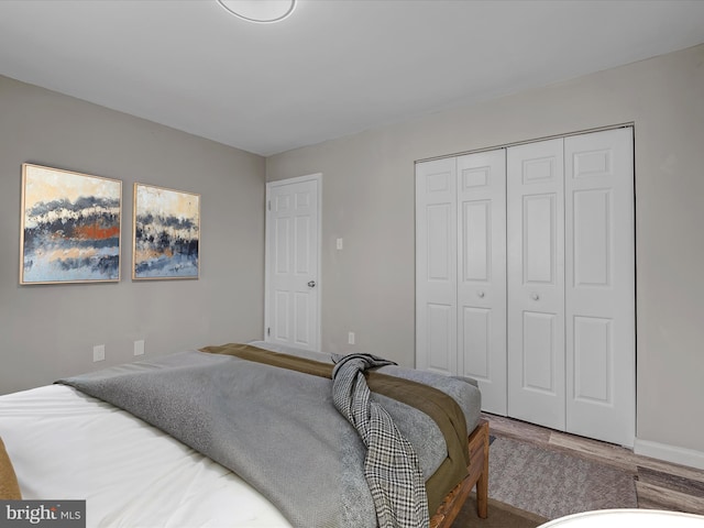 bedroom with hardwood / wood-style flooring and a closet