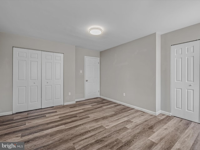 unfurnished bedroom with hardwood / wood-style floors and a closet