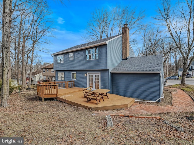 rear view of property with a deck and french doors