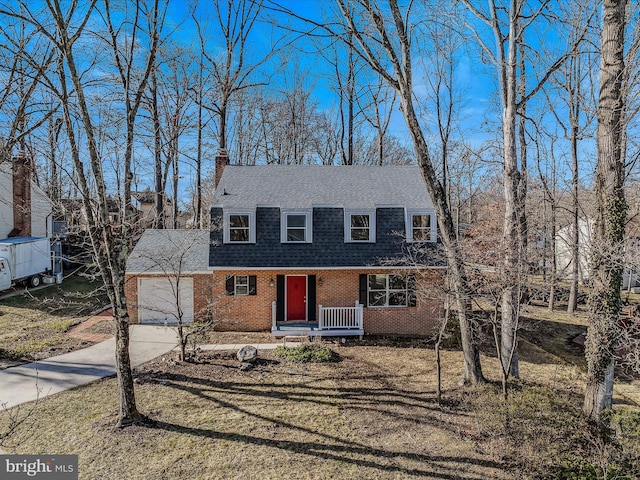 view of front facade with a porch, a garage, and a front yard