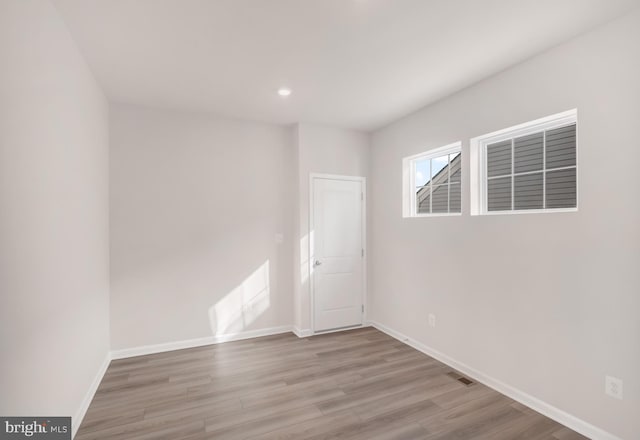 unfurnished room with light hardwood / wood-style flooring