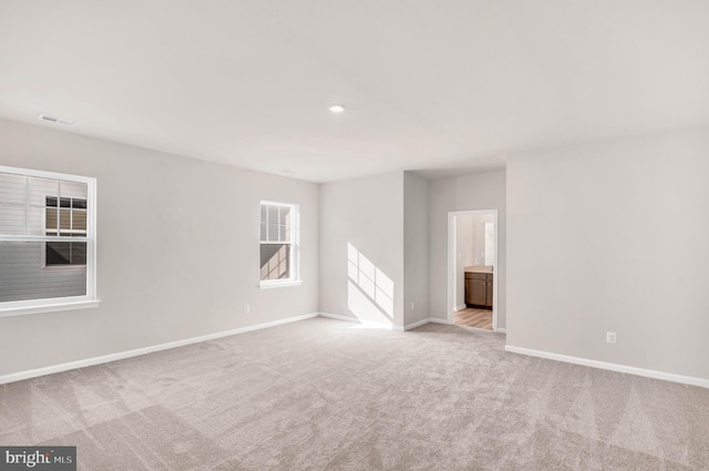 unfurnished room featuring light colored carpet