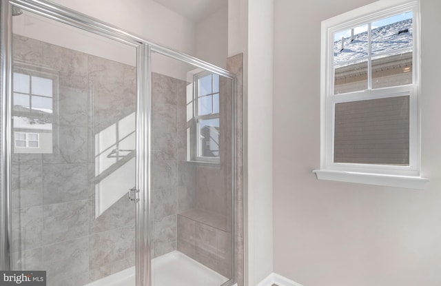 bathroom with a shower with door