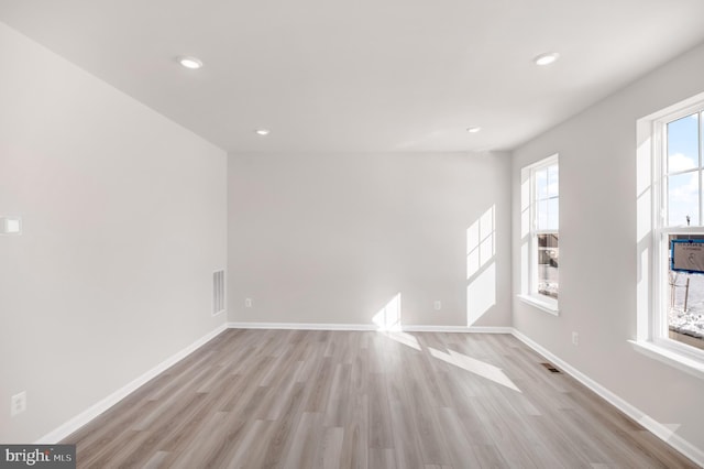 spare room featuring light wood-type flooring