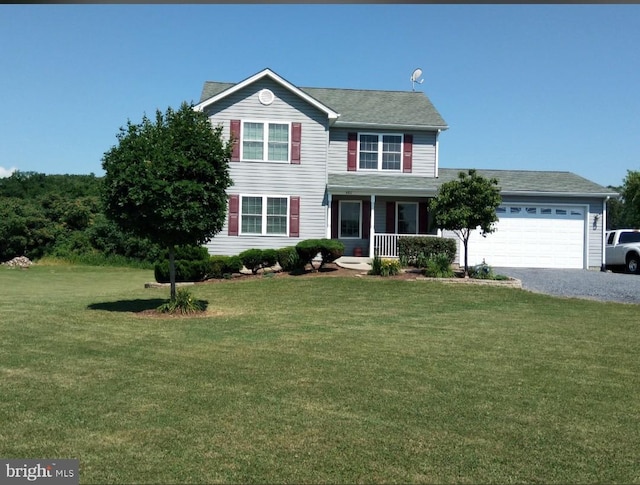 view of front of home featuring a garage, a porch, and a front lawn