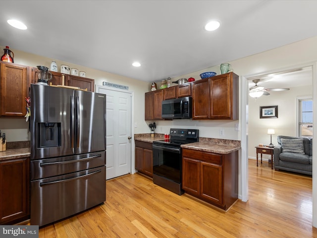 kitchen featuring ceiling fan, black range with electric cooktop, light hardwood / wood-style floors, and stainless steel fridge with ice dispenser