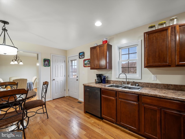 kitchen with sink, decorative light fixtures, light hardwood / wood-style flooring, and dishwasher