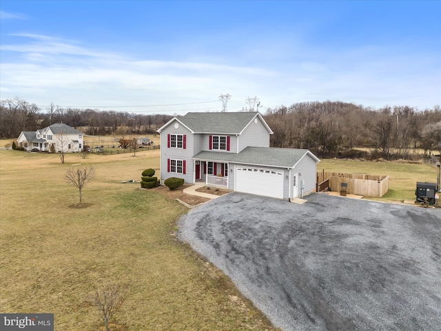 view of front of property featuring a garage, a front yard, and a porch