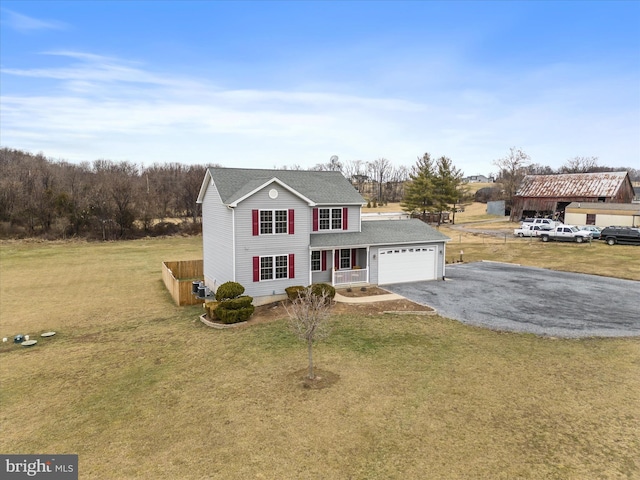 view of front of property featuring a garage, a front lawn, and a porch