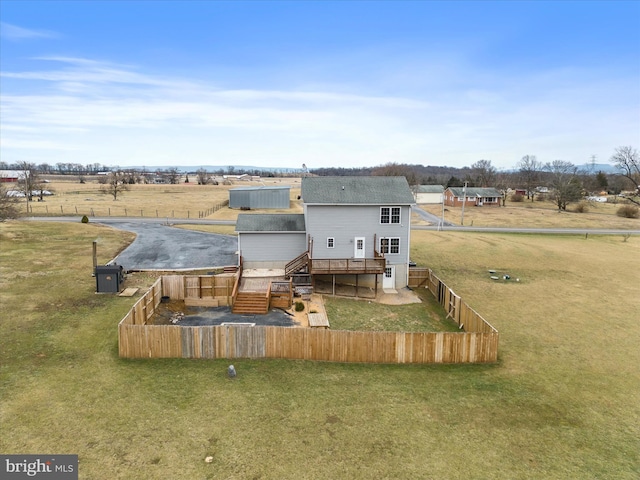 back of house with a wooden deck and a rural view