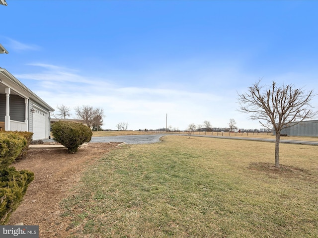 view of yard with a rural view