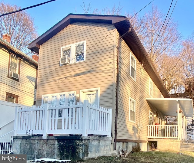 back of property with covered porch