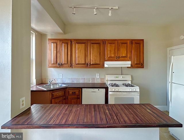 kitchen with wood counters, sink, and white appliances