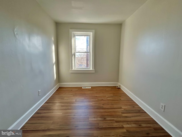 unfurnished room with dark hardwood / wood-style floors