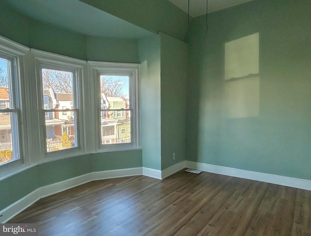 empty room with dark hardwood / wood-style floors