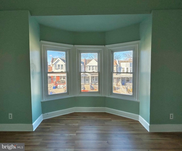 unfurnished room featuring wood-type flooring