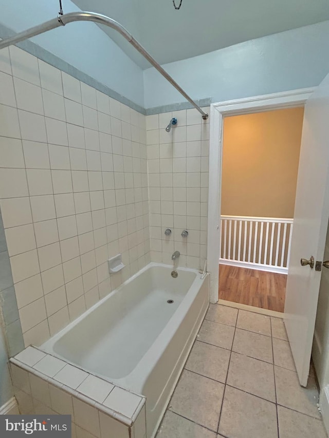 bathroom with tile patterned flooring and tiled shower / bath