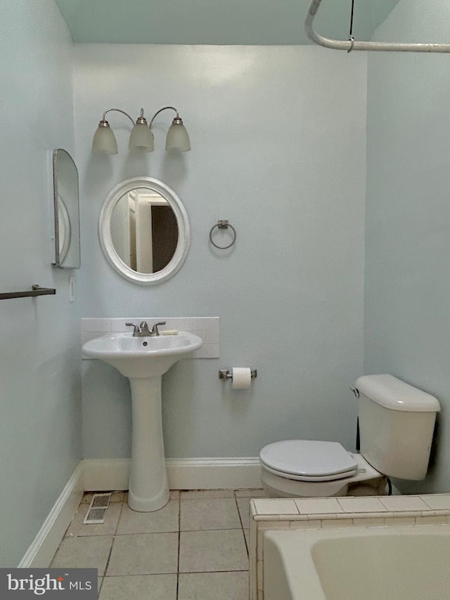 bathroom featuring toilet and tile patterned flooring